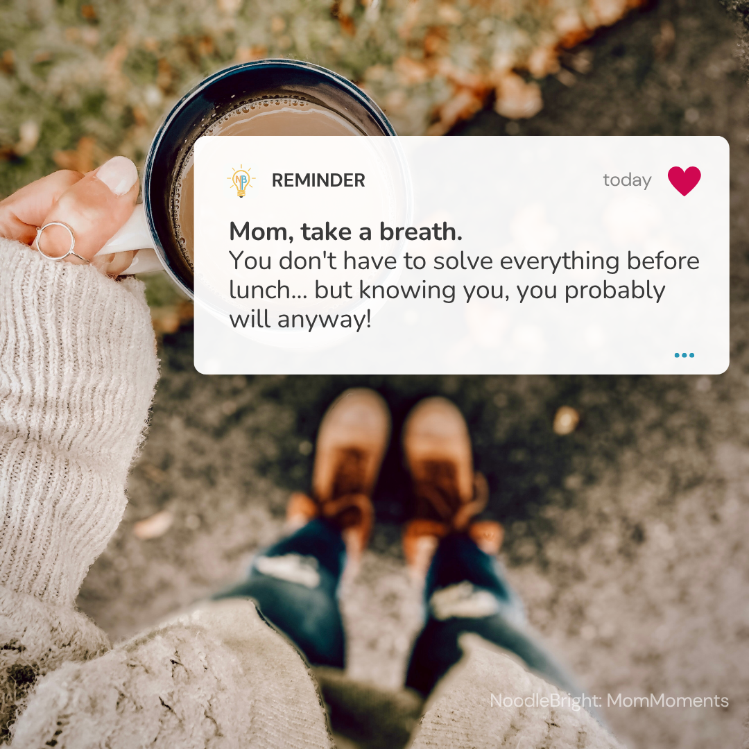 A person holds a mug outdoors while wearing a cream knit sweater and brown boots. A white reminder card overlay reads, 'Mom, take a breath.